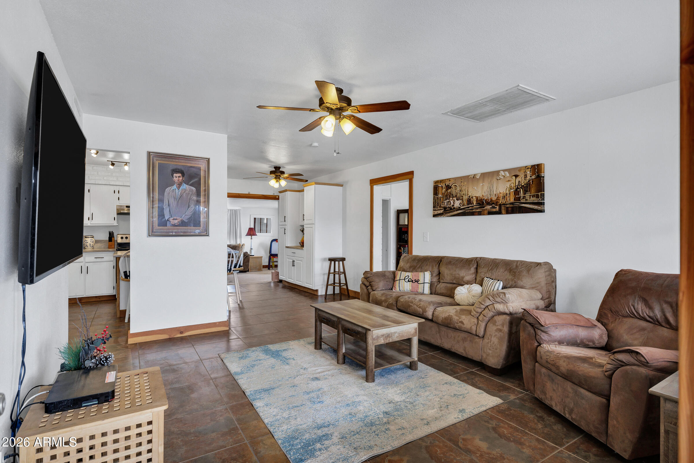 6618 North Evans Road Coolidge, AZ 85128 - Photo 5 of 48 a living room with furniture a flat screen tv and a fireplace