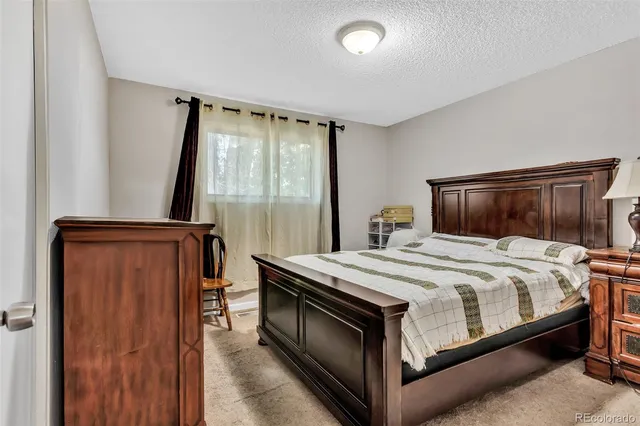 a bedroom with a bed and a mirror