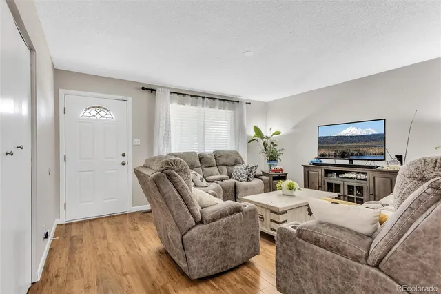 a kitchen with stainless steel appliances granite countertop a stove top oven a sink a dining table and chairs