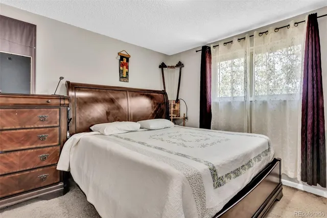 a bedroom with a bed and a mirror