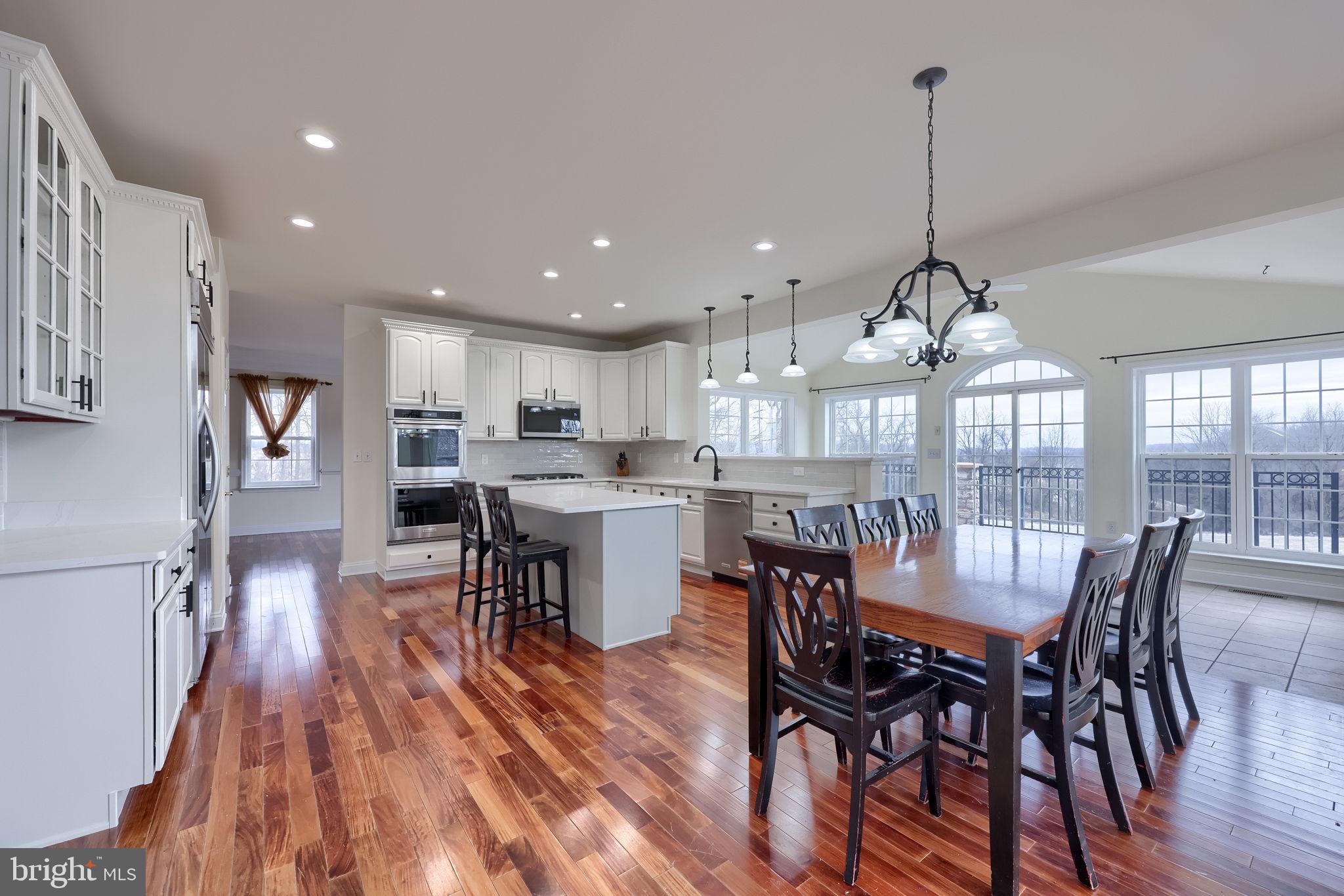 18183 Piedmont Road Stewartstown, PA 17363 - Photo 12 of 81 a view of a dining room and livingroom with furniture wooden floor a chandelier
