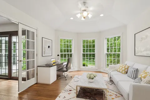 a living room with furniture and large windows