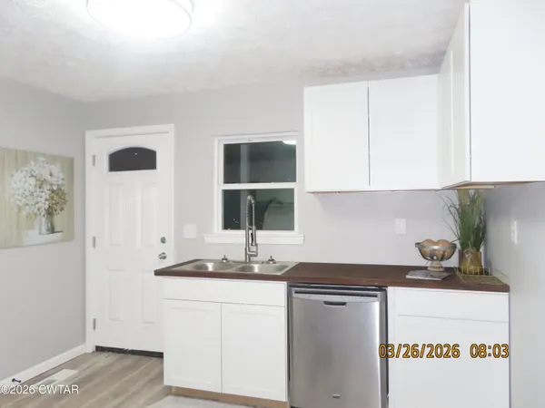 a kitchen with a sink and cabinets