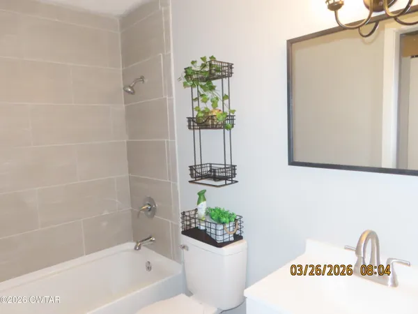 a bathroom with a bathtub a sink and a shower