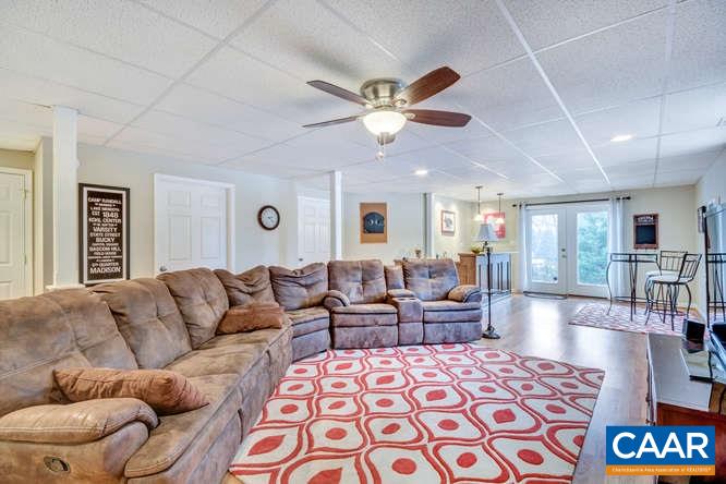 798 Cedar Grove Road Ruckersville, VA 22968 - Photo 19 of 29 a living room with furniture and a chandelier