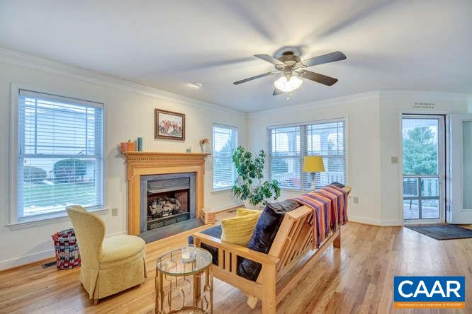 798 Cedar Grove Road Ruckersville, VA 22968 - Photo 6 of 29 a living room with furniture a fireplace and a large window