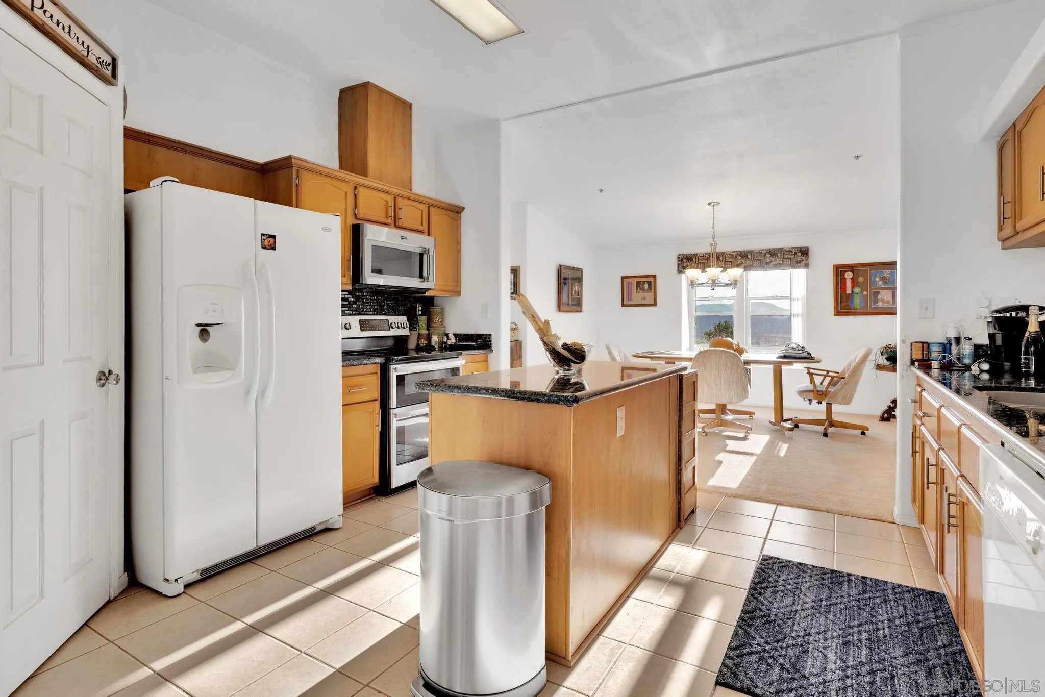 3240 Chimney Rock Road Ranchita, CA 92066 - Photo 22 of 34 a kitchen with stainless steel appliances granite countertop a refrigerator a stove and a sink with wooden floor