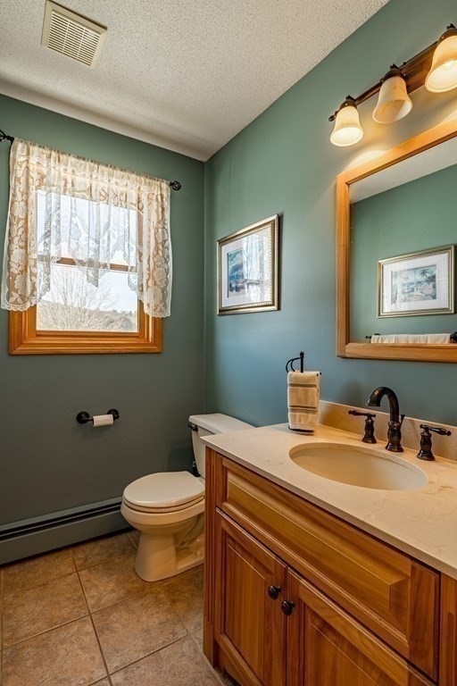 158 Scantic Road Hampden, MA 01036 - Photo 19 of 42 a bathroom with a toilet sink and mirror