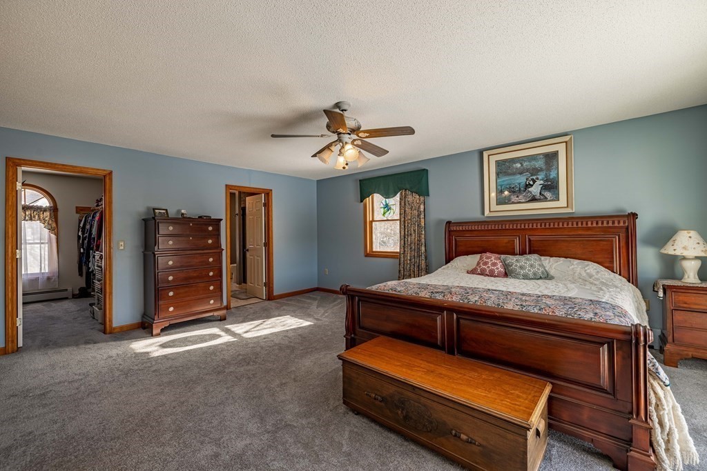158 Scantic Road Hampden, MA 01036 - Photo 20 of 42 a bedroom with a bed and a chandelier
