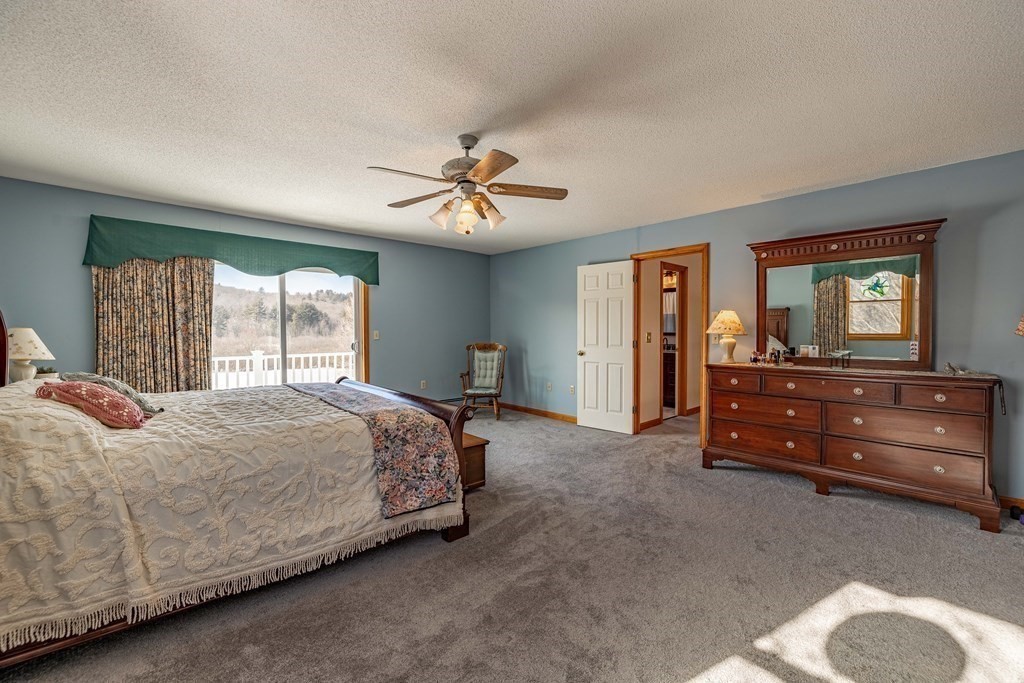 158 Scantic Road Hampden, MA 01036 - Photo 21 of 42 a bedroom with a bed and a chandelier