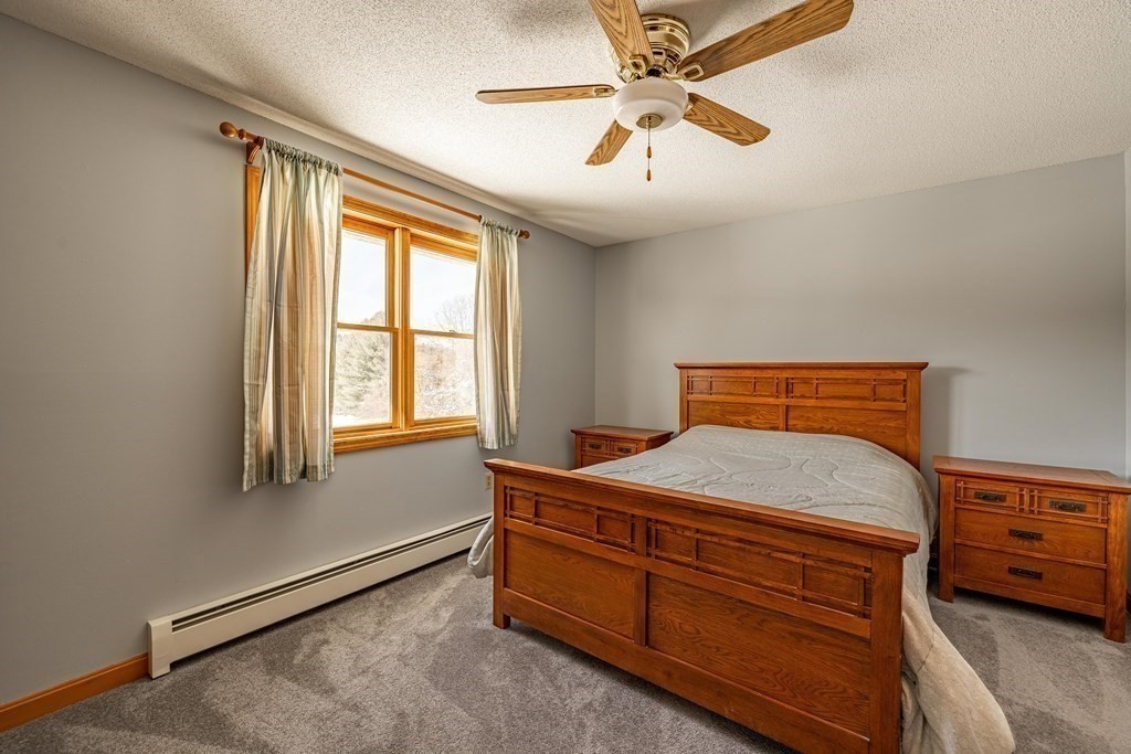158 Scantic Road Hampden, MA 01036 - Photo 25 of 42 a bedroom with a bed and a chandelier
