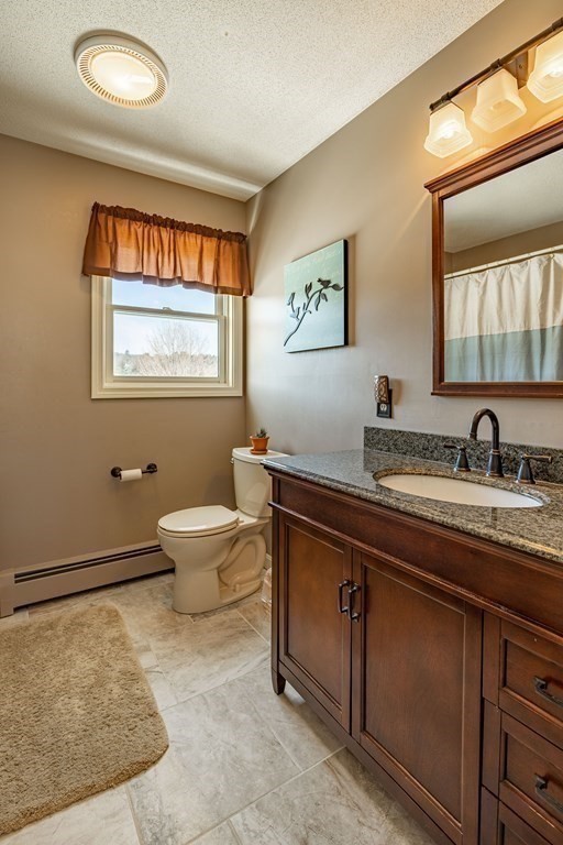 158 Scantic Road Hampden, MA 01036 - Photo 27 of 42 a spacious bathroom with a granite countertop sink a toilet and a window