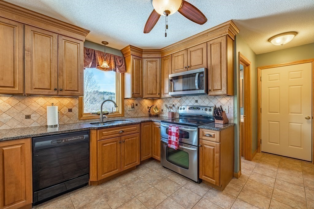 158 Scantic Road Hampden, MA 01036 - Photo 6 of 42 a kitchen with stainless steel appliances granite countertop a stove sink and microwave