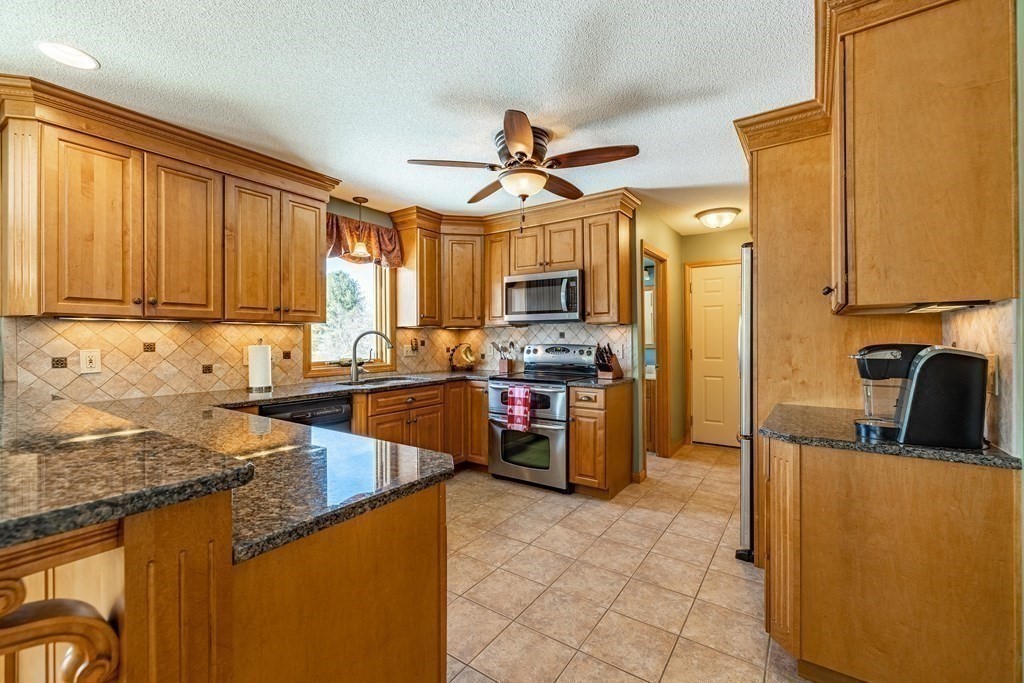 158 Scantic Road Hampden, MA 01036 - Photo 7 of 42 a kitchen with granite countertop a sink counter top space appliances and cabinets
