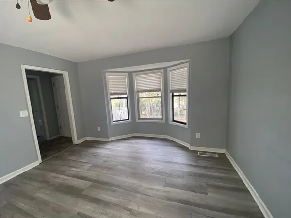 a kitchen with granite countertop a white stove top oven and cabinets