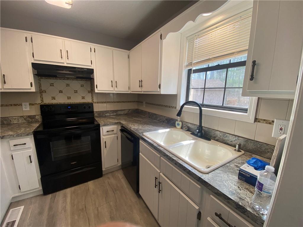 64 Arnold Road Cartersville, GA 30120 - Photo 5 of 23 a kitchen with granite countertop a sink stainless steel appliances and cabinets