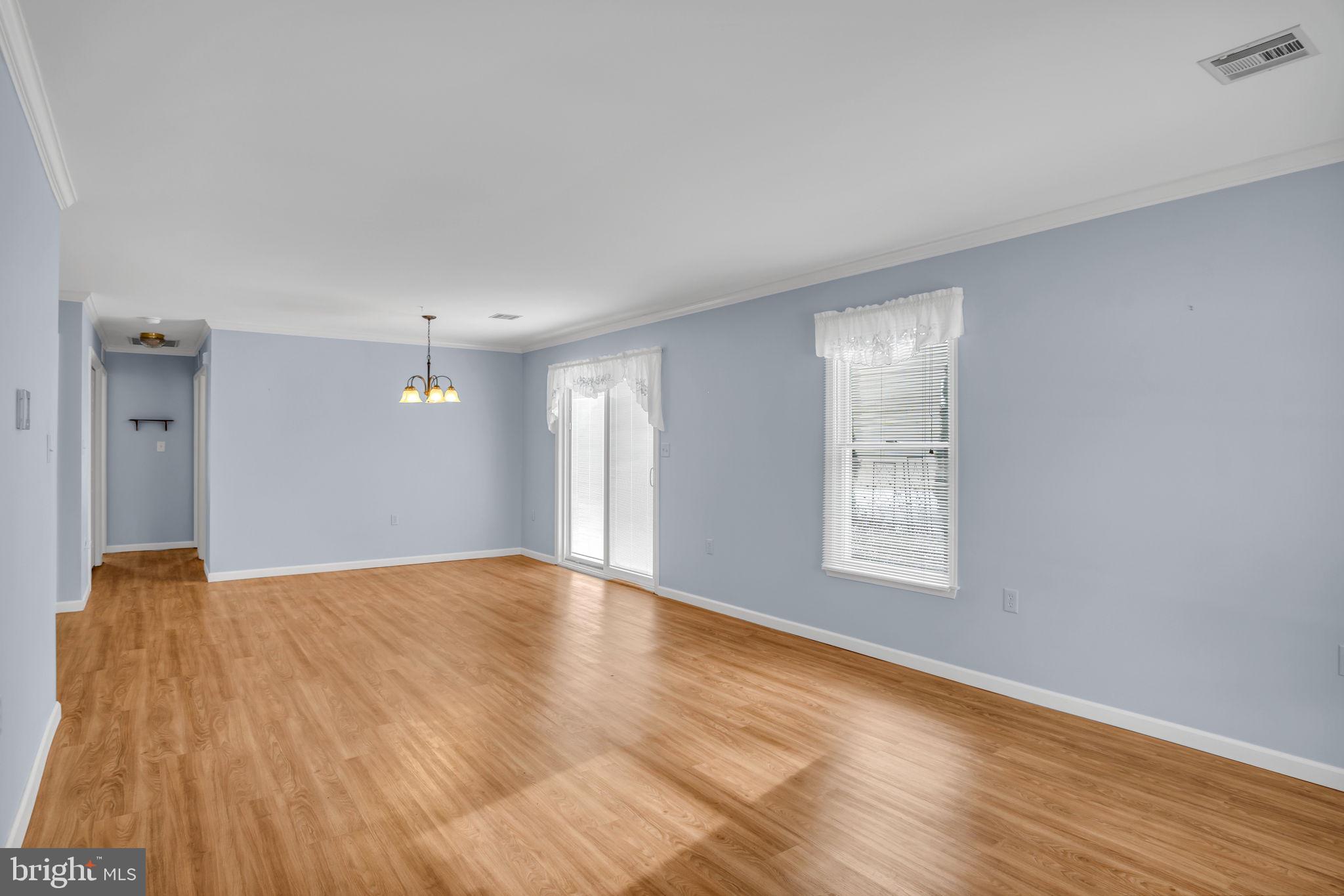 433 Mill Race Road Carlisle, PA 17013 - Photo 4 of 27 a view of an empty room with wooden floor and a window