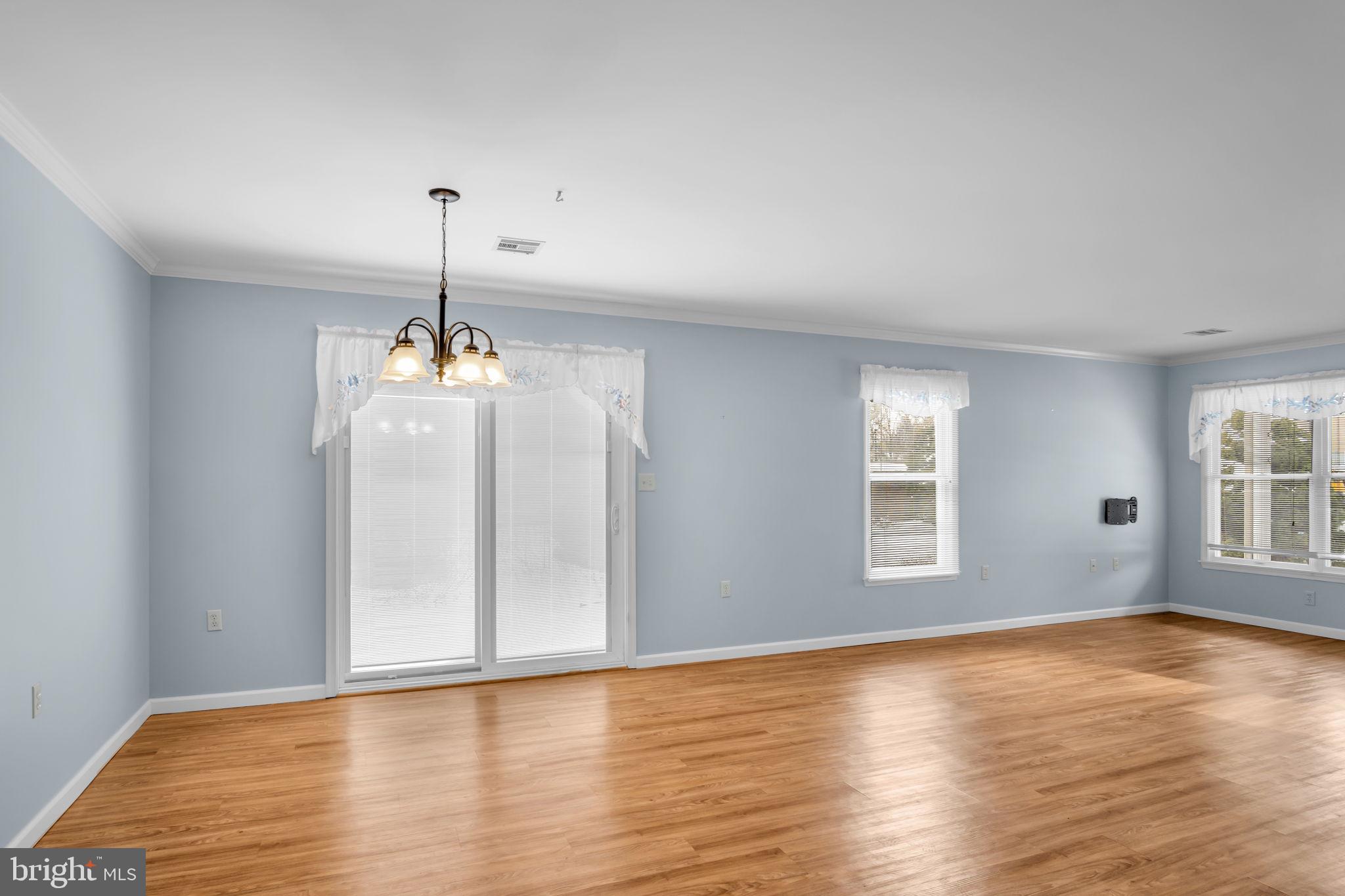 433 Mill Race Road Carlisle, PA 17013 - Photo 8 of 27 a view of an empty room with window and wooden floor