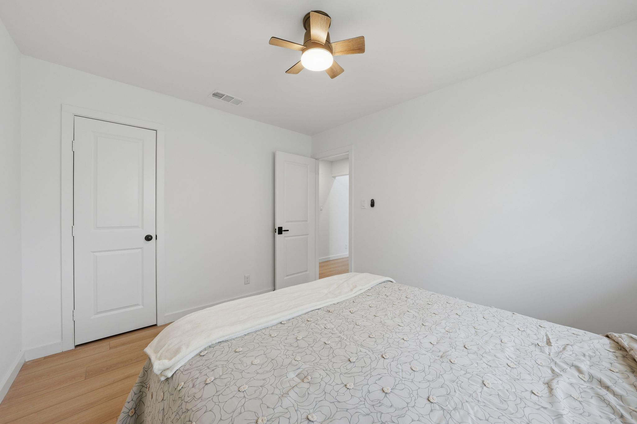 6804 Meadow Run Austin, TX 78745 - Photo 17 of 34 a bedroom with a bed and a chandelier fan