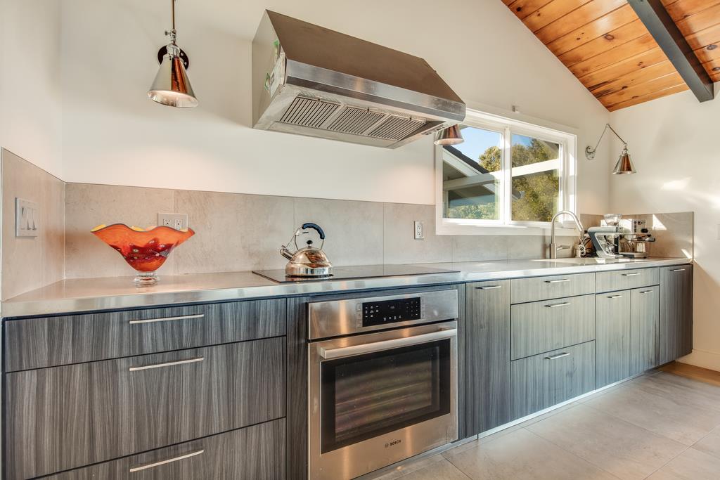 16984 Bohlman Road Saratoga, CA 95070 - Photo 18 of 50 a kitchen with stainless steel appliances granite countertop a sink and cabinets