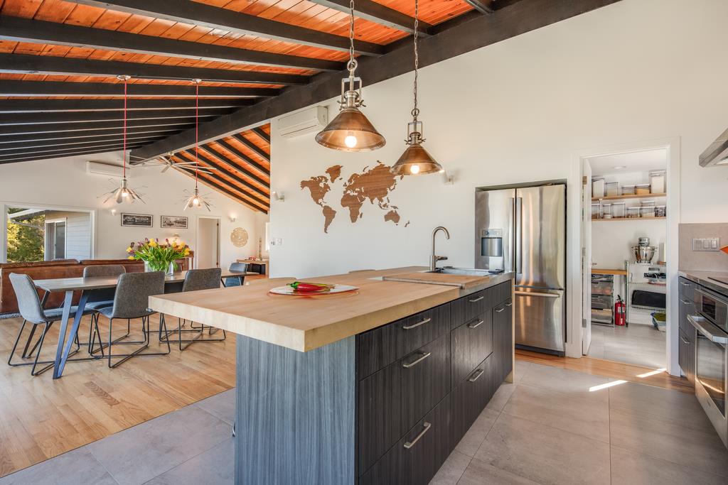 16984 Bohlman Road Saratoga, CA 95070 - Photo 20 of 50 a kitchen with a stove a refrigerator a dining table and chairs with wooden floor