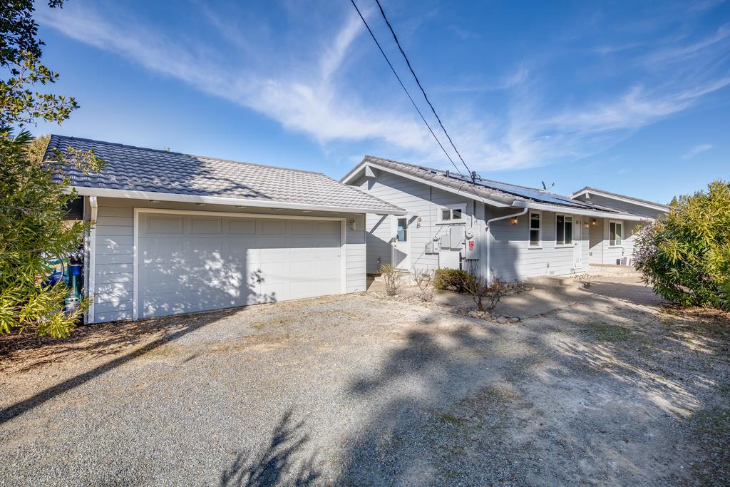 16984 Bohlman Road Saratoga, CA 95070 - Photo 2 of 50 a front view of a house with a yard and garage