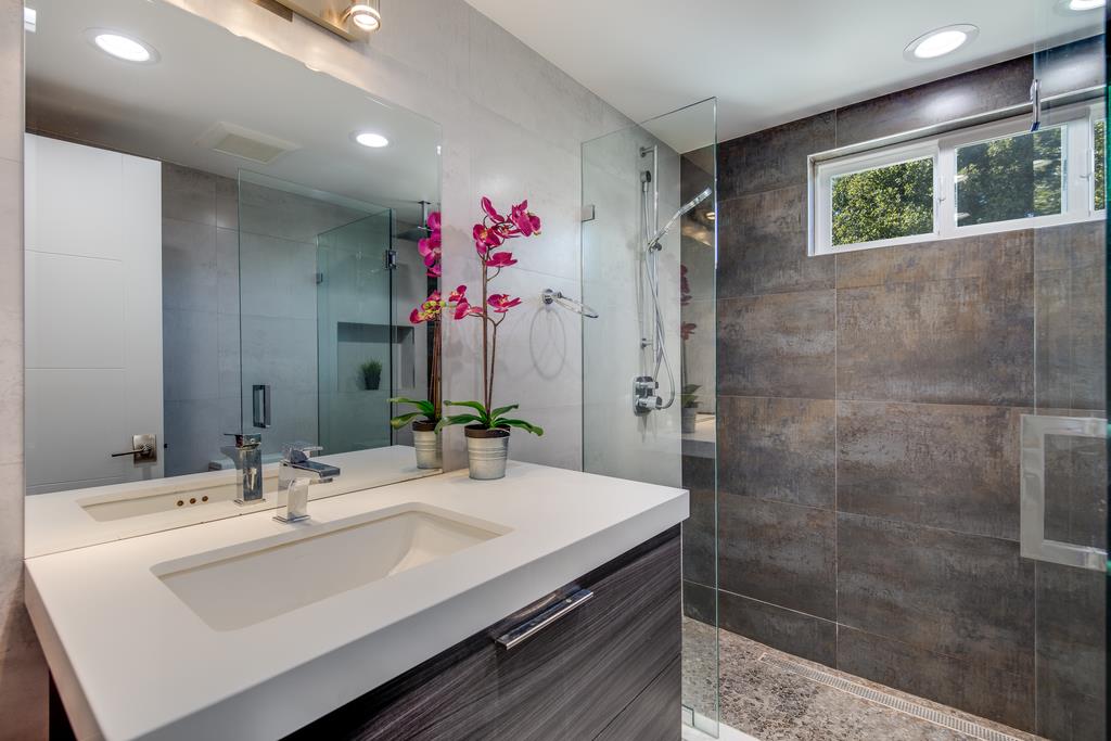 16984 Bohlman Road Saratoga, CA 95070 - Photo 31 of 50 a bathroom with a sink and a mirror