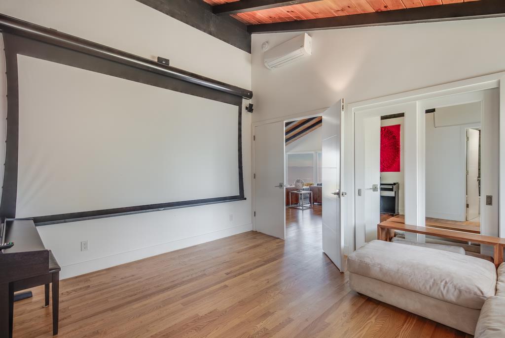 16984 Bohlman Road Saratoga, CA 95070 - Photo 32 of 50 a hallway with wooden floor and furniture