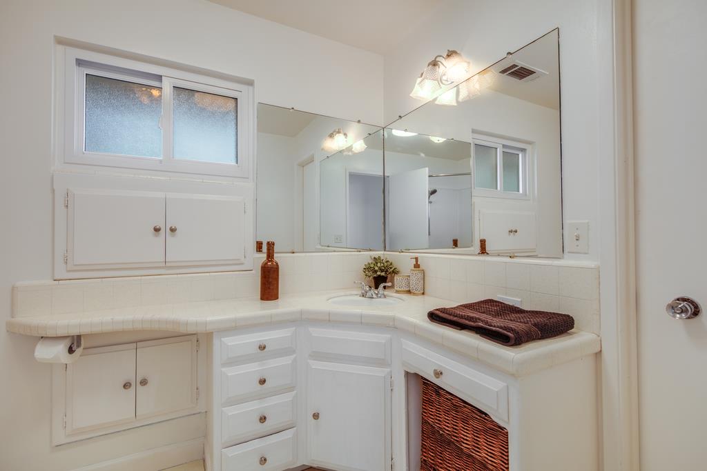 16984 Bohlman Road Saratoga, CA 95070 - Photo 33 of 50 a bathroom with a sink vanity and a mirror