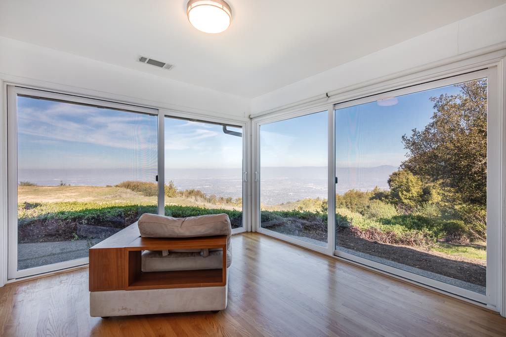 16984 Bohlman Road Saratoga, CA 95070 - Photo 35 of 50 a living room with couch and a floor to ceiling window