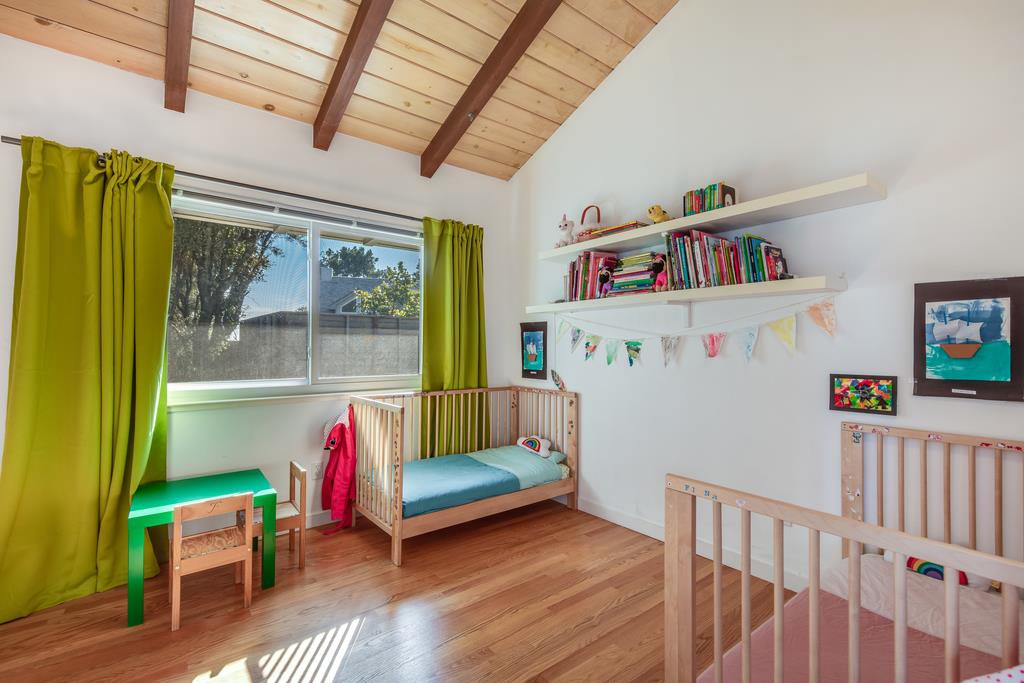 16984 Bohlman Road Saratoga, CA 95070 - Photo 41 of 50 a living room with furniture and a book shelf