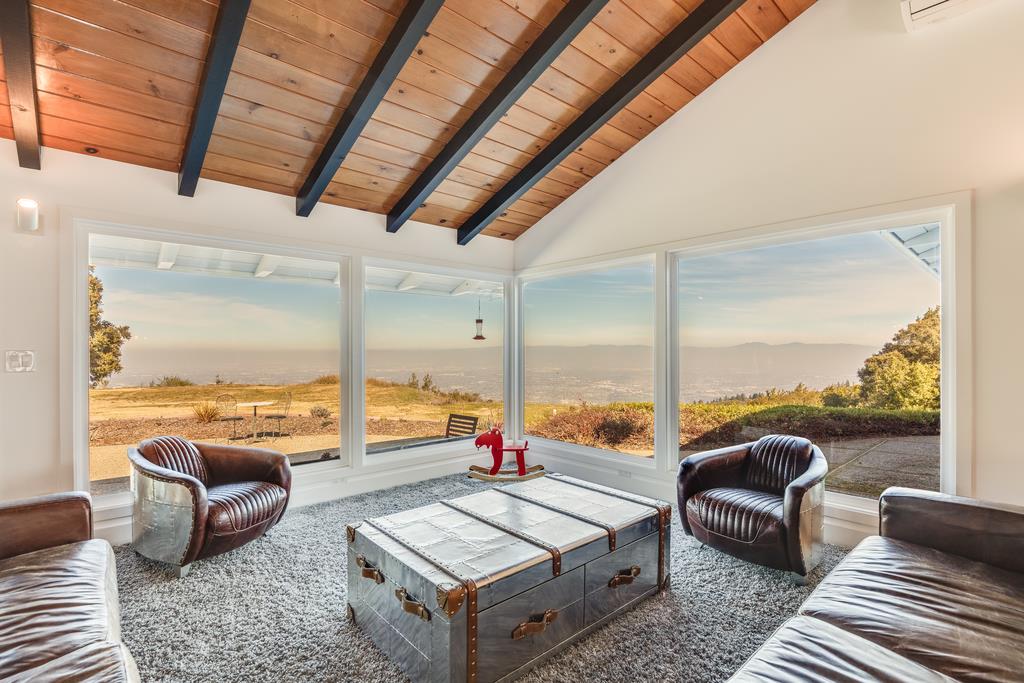 16984 Bohlman Road Saratoga, CA 95070 - Photo 9 of 50 a living room with furniture and a floor to ceiling window