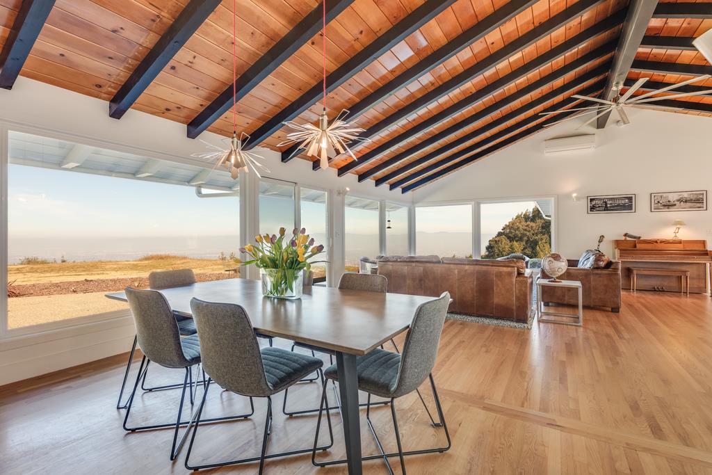 16984 Bohlman Road Saratoga, CA 95070 - Photo 10 of 50 a dining room with furniture and a floor to ceiling window