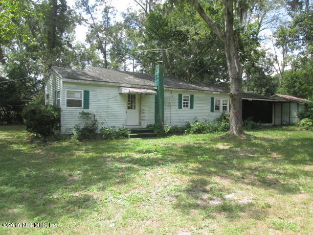 6252 Firestone Road Jacksonville, FL 32244 - Photo 1 of 12 a backyard of a house with large trees and plants