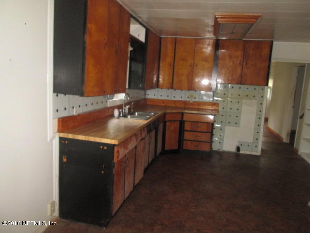 6252 Firestone Road Jacksonville, FL 32244 - Photo 4 of 12 a bathroom with a sink and a mirror