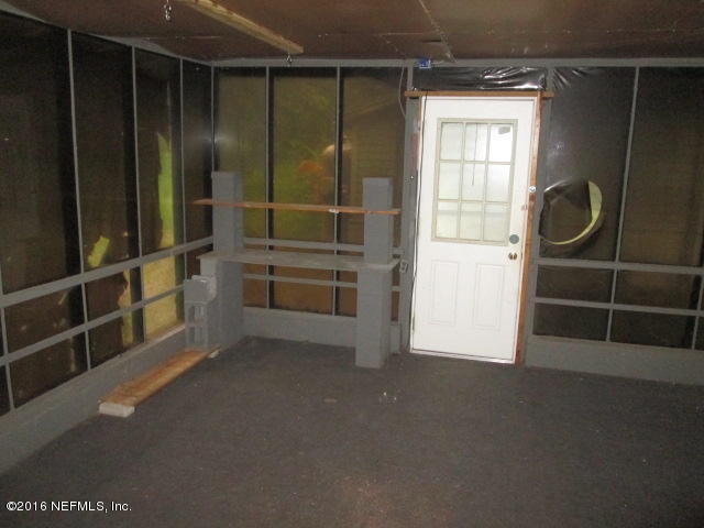 6252 Firestone Road Jacksonville, FL 32244 - Photo 6 of 12 a view of empty room with windows