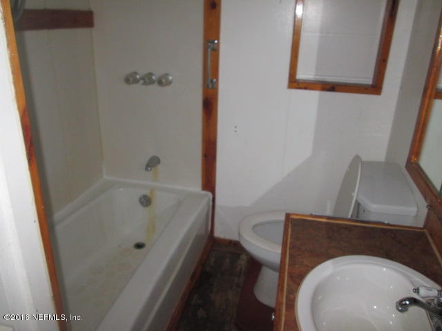6252 Firestone Road Jacksonville, FL 32244 - Photo 9 of 12 a bathroom with a sink and a toilet