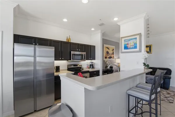 a large kitchen with a table and chairs