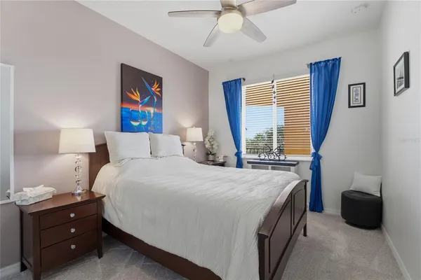 a bedroom with a bed and a painting on the wall