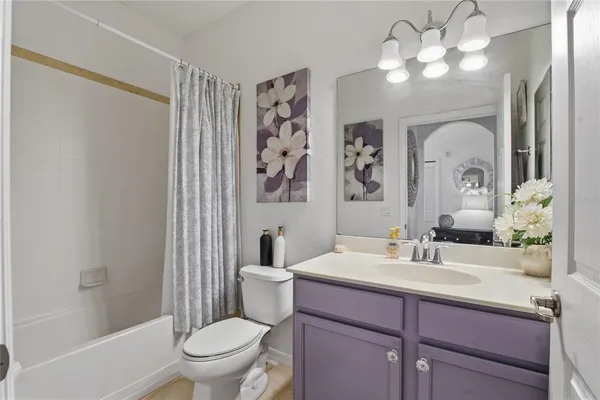 a bedroom with a bed and a night stand