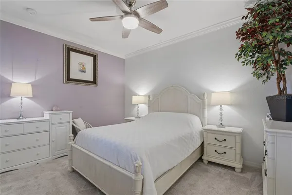 a bedroom with a bed and a painting on the wall