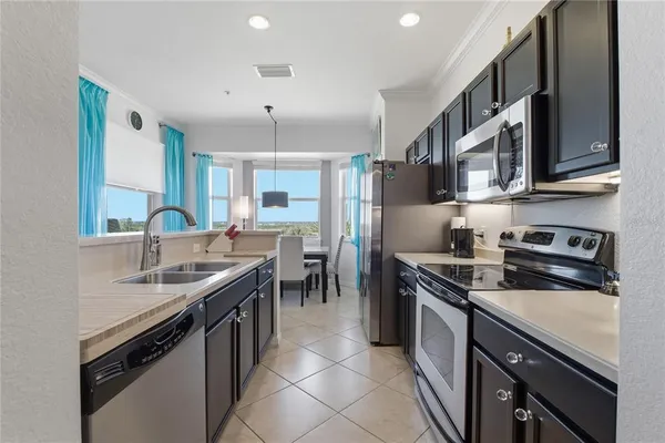 a kitchen with a sink and chairs