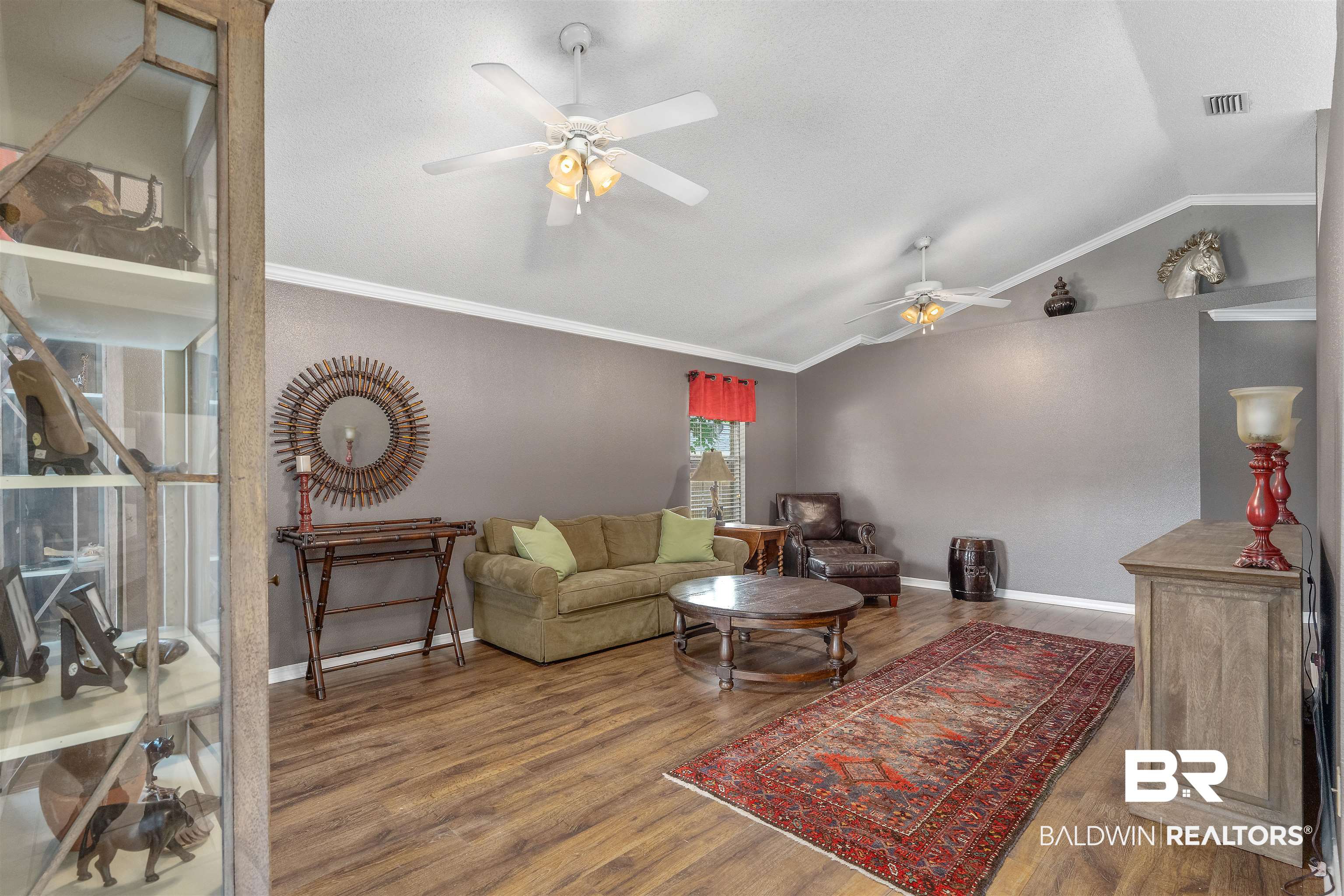 11097 Pontchartrain Loop Daphne, AL 36526 - Photo 16 of 28 Living room with ceiling fan, wood finished floors, vaulted ceiling, and ornamental molding