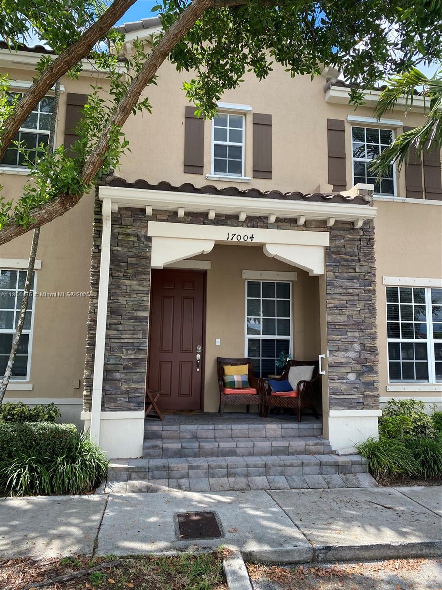 17004 Southwest 95th Terrace Miami, FL 33196 - Photo 1 of 15 a front view of a house with a yard