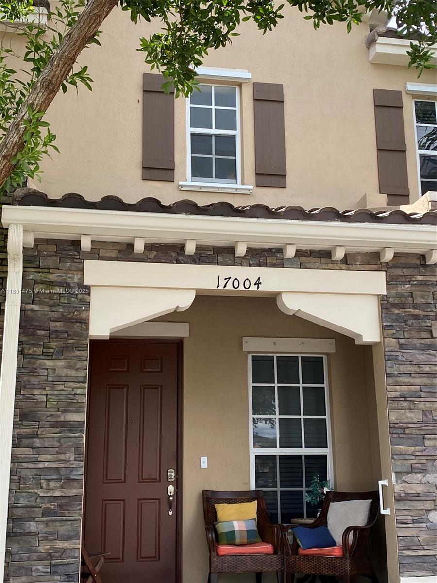 17004 Southwest 95th Terrace Miami, FL 33196 - Photo 2 of 15 a front view of a house with a garage