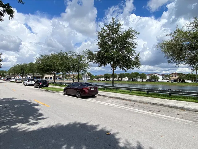 a view of outdoor space with swimming pool and green space