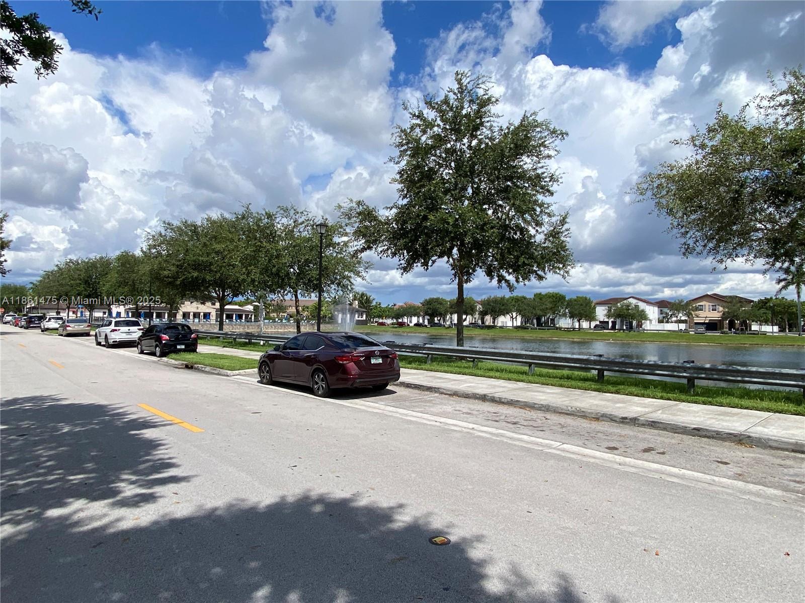 17004 Southwest 95th Terrace Miami, FL 33196 - Photo 6 of 15 a view of outdoor space with swimming pool and green space