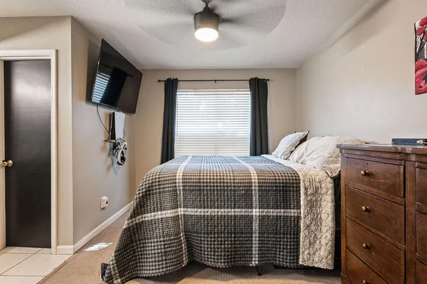 a bedroom with a bed and flat screen tv
