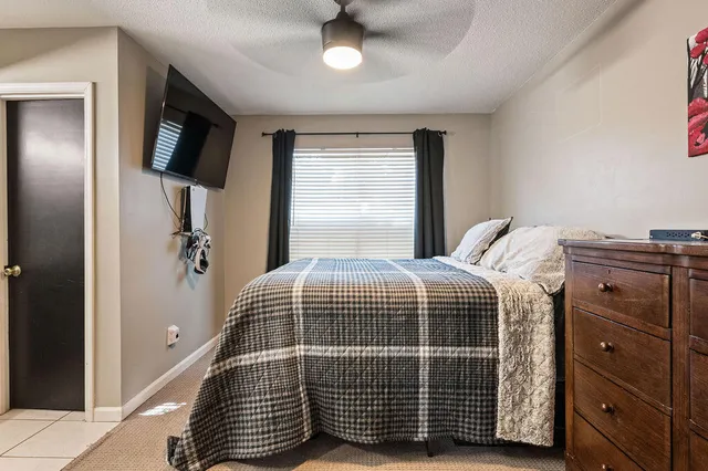 a bedroom with a bed and flat screen tv