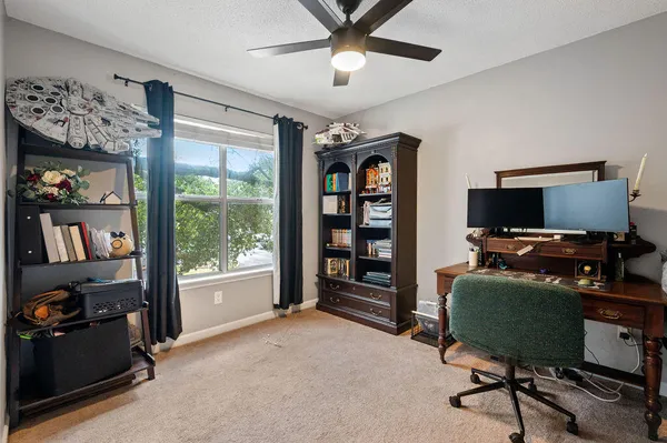a view of a livingroom with workspace and a window